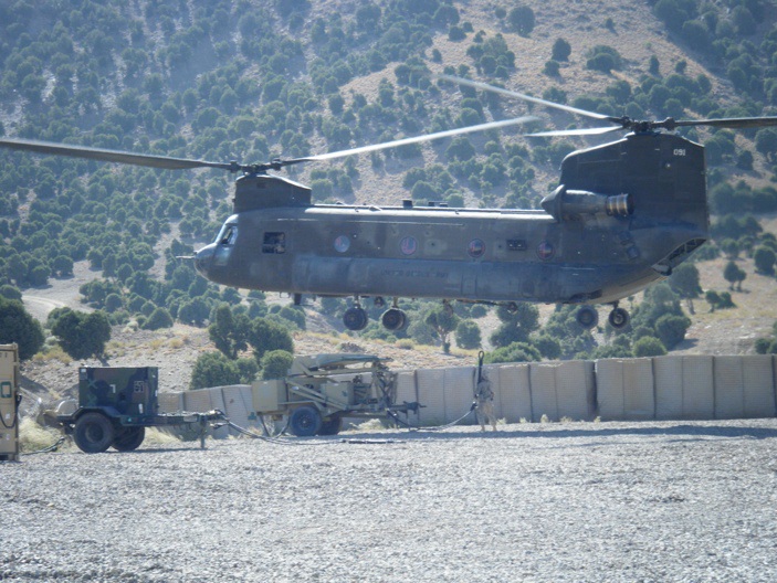 Sgt. Siebeda hooking up a slingload under a Chinook. How'd you like that job!